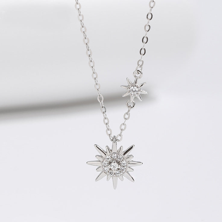 A detailed studio shot of the 925 sterling silver sparkling starburst double sun necklace, showcasing its two intricate pendants with clear gemstones.