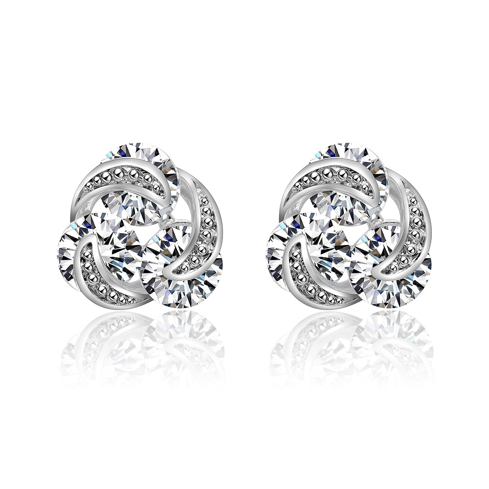 A pair of lovely silver CZ knot stud earrings with a swirling design and clear crystals, showcasing their classic and elegant style.
