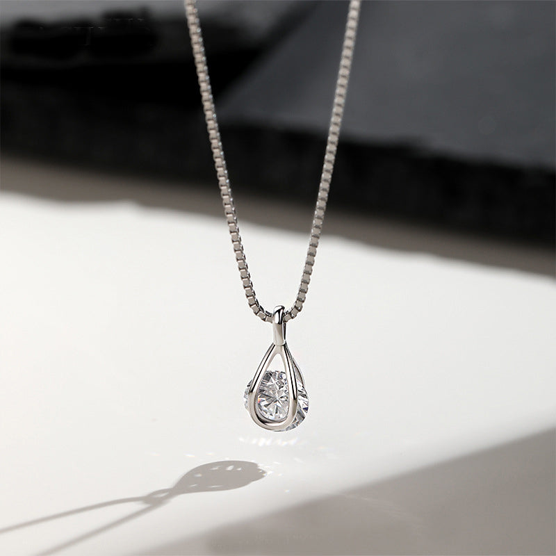 A high-quality studio shot of a 925 sterling silver necklace featuring an elegant teardrop pendant with a single, brilliant cubic zirconia stone.