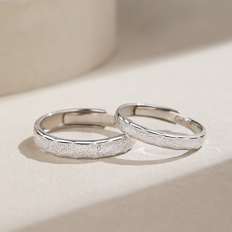 A pair of 925 sterling silver couple promise rings with a simple, textured sanded design, displayed on a white background.