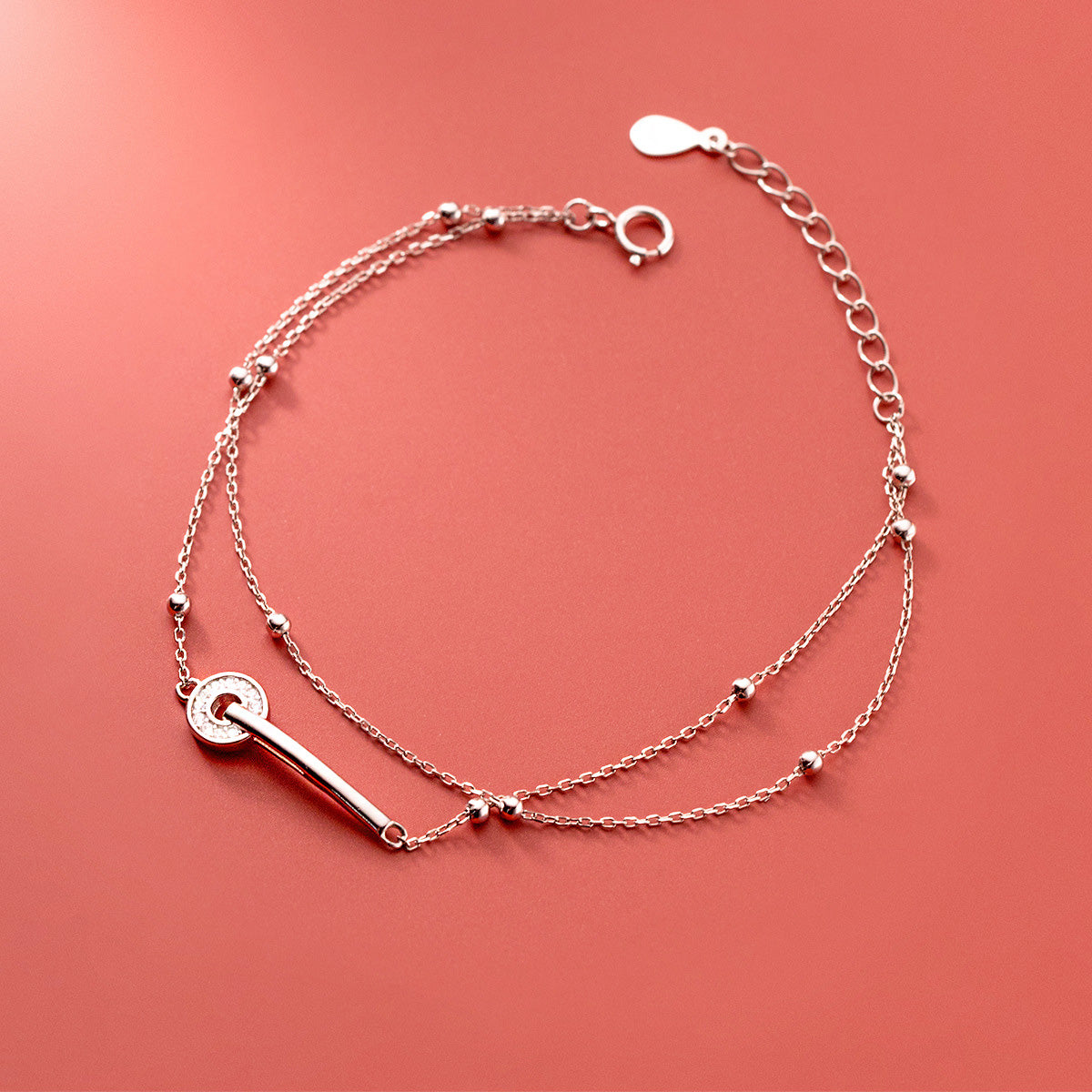 A close-up of a wholesale 925 sterling silver double-strand bead chain bracelet, featuring an elegant toggle clasp.