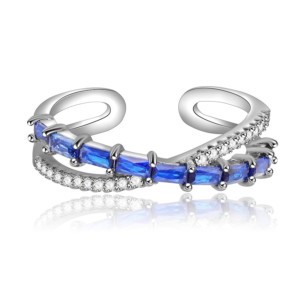 Front view of the Cross Baguette-cut Blue Sapphire Ring, showcasing its rhodium-plated brass band with alternating blue sapphires and white cubic zirconia in a unique wavy design.