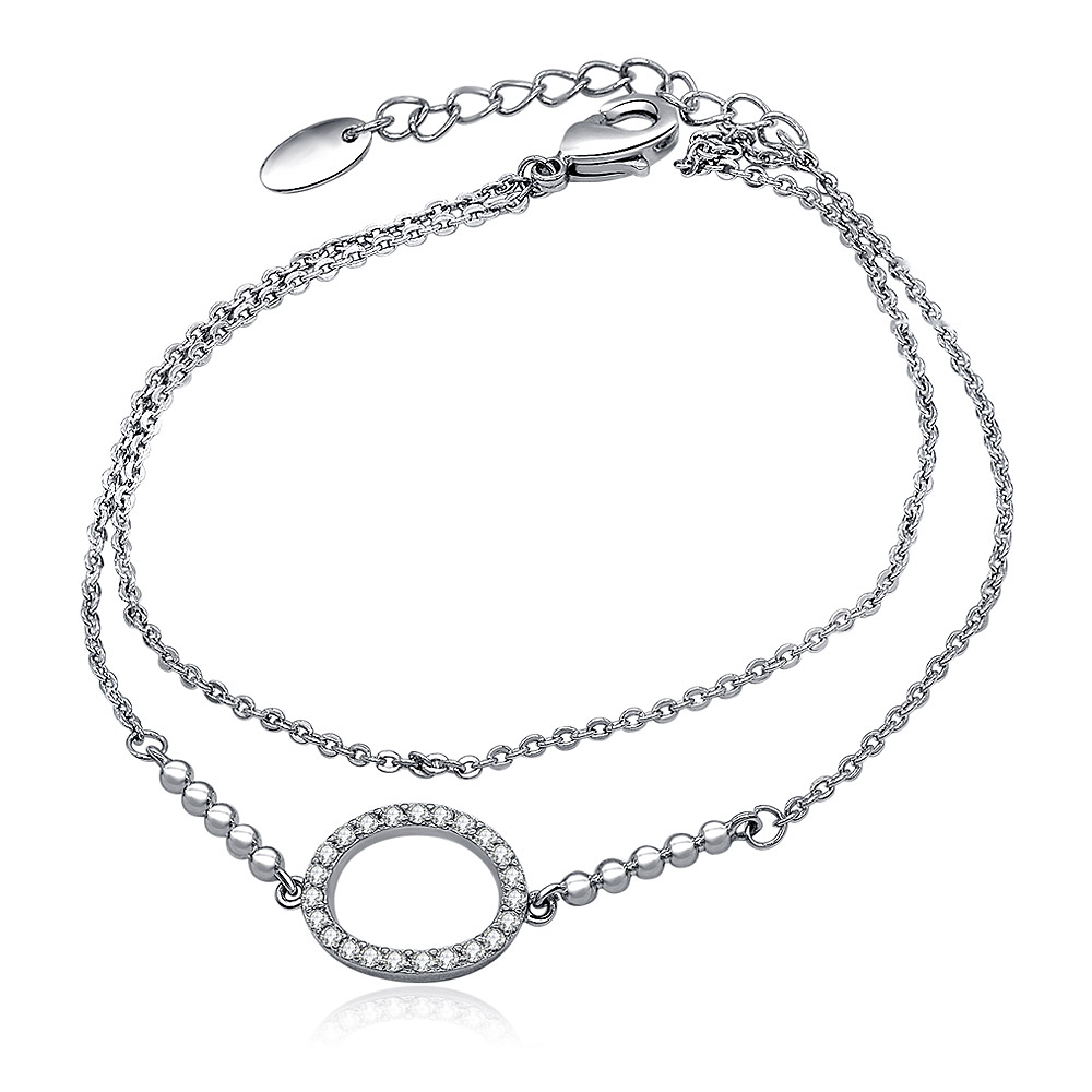 The CZ Oval Charm Link Layered Bracelet displayed on a white background, highlighting its double-chain design and the central circular pendant set with brilliant cubic zirconia stones.