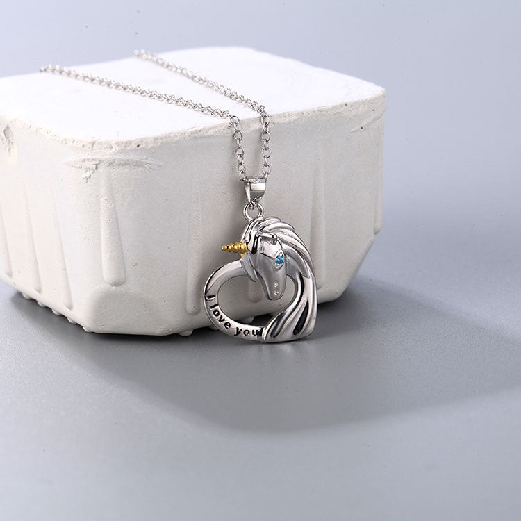 A close-up of the 925 sterling silver unicorn pendant necklace, featuring a delicate unicorn charm resting on a heart-shaped base engraved with 'I love you'.