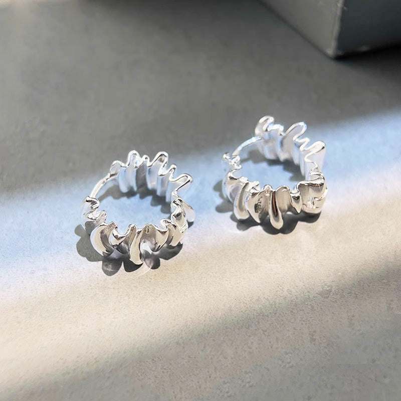 A pair of 925 sterling silver hoop earrings with a simple, irregular pleated C-shaped design, displayed on a clean background.