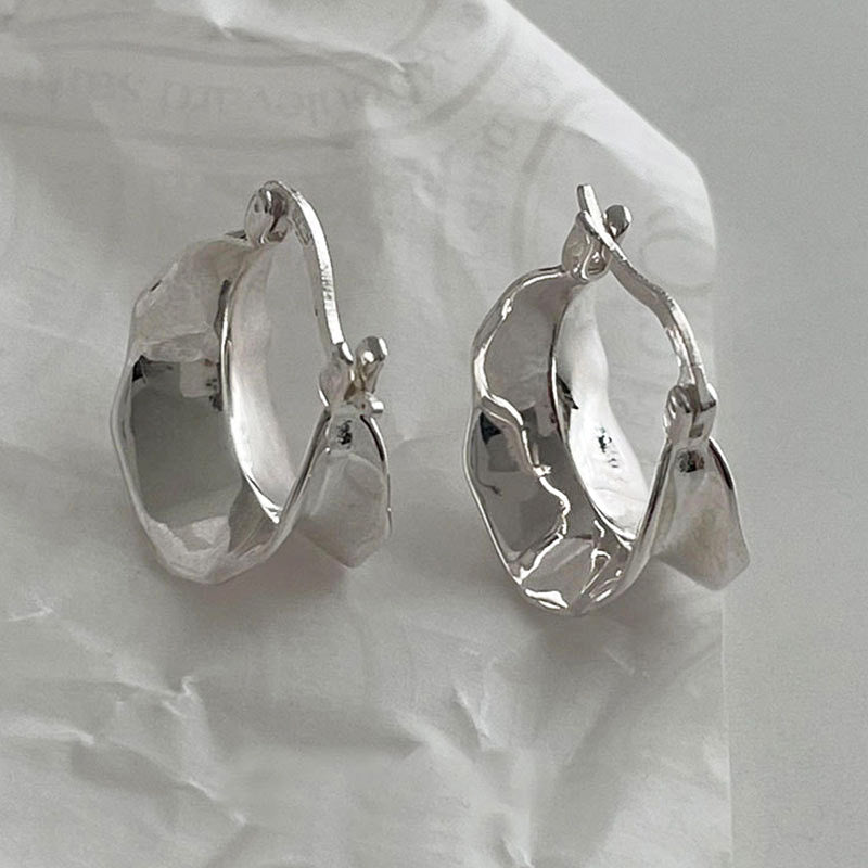 A pair of 925 sterling silver wide wave hoop earrings showcasing their unique, elegant wavy design against a clean background.