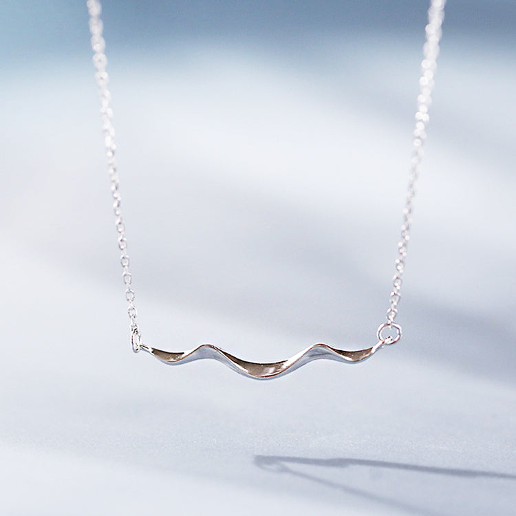 A close-up of the 925 Sterling Silver Simple Coastline Wave Necklace, showcasing the detailed and elegant wavy pendant design.