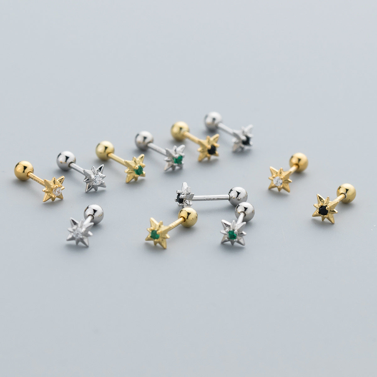 A collection of 925 sterling silver tiny star screw stud earrings with cubic zirconia, displayed in both silver and gold finishes with various gemstone colors.