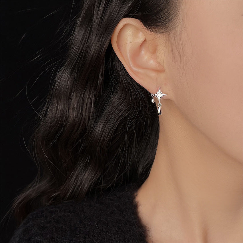 A model showcasing the elegant Star Drop Earring, highlighting its celestial design with CZ zircon stones and how it dangles gracefully.