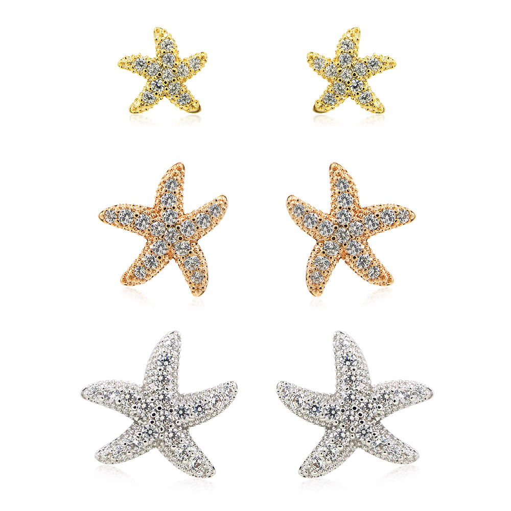 A set of three starfish stud earrings in gold, rose gold, and silver finishes, each embellished with sparkling clear cubic zirconia stones.