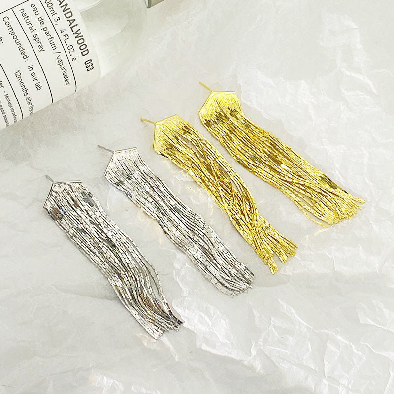A promotional shot of 925 sterling silver exaggerated long chain tassel earrings, displaying both silver and gold color options.