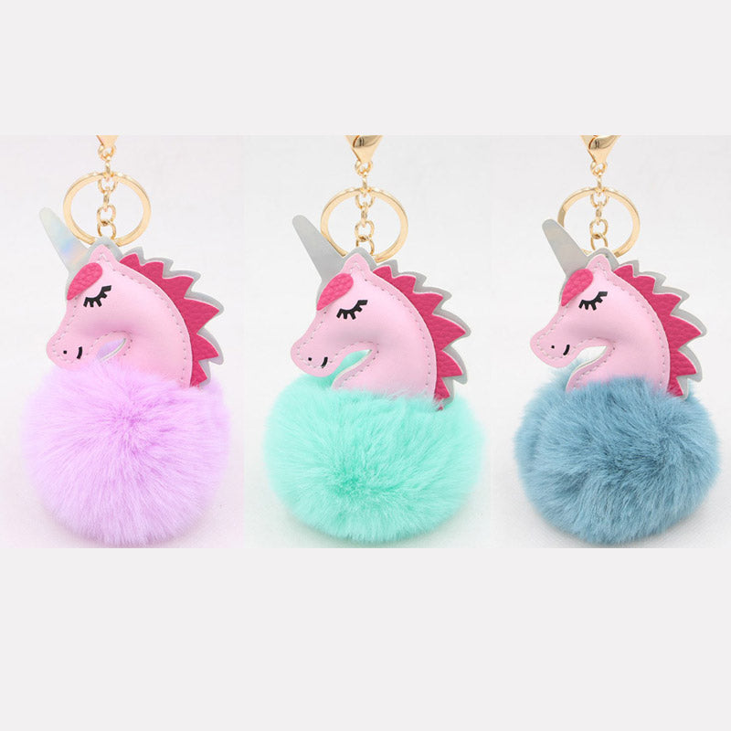 A vibrant collection of PU leather unicorn bag charms, each with a different colored fluffy pom-pom, showcasing the product's variety.