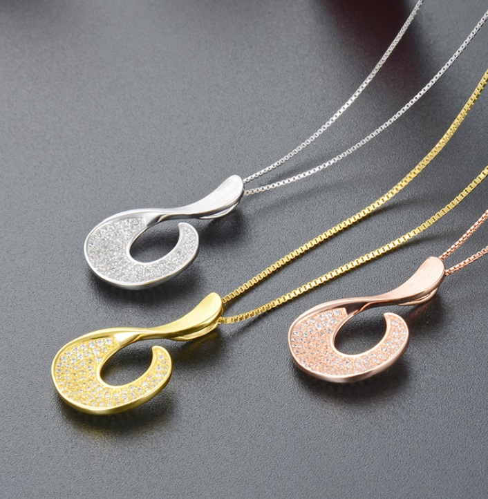 Three 925 sterling silver micropaved geometric hook necklaces in silver, gold, and rose gold finishes, showcasing the available color variations.