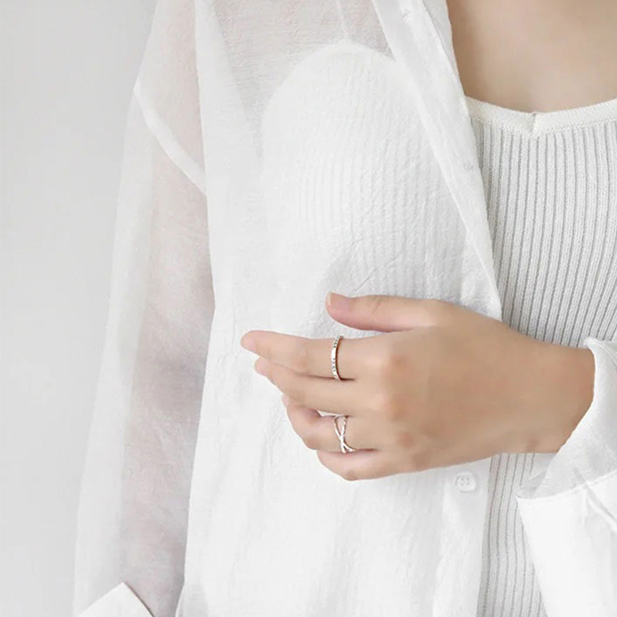 Model wearing the minimalist sterling silver crossover rings set, showcasing the adjustable double-band design. Perfect for wholesale fashion jewelry.