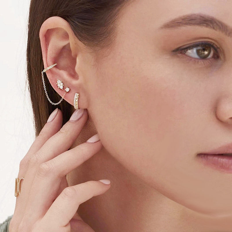 A model showcasing the elegant 925 sterling silver zircon chain-link cuff earrings, highlighting their stylish design when worn.