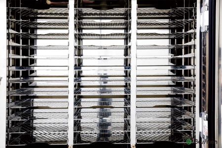 The Reticle Pod Nitrogen Cabinet has slanted shelves that prevent photomasks from slipping, ensuring safe storage.