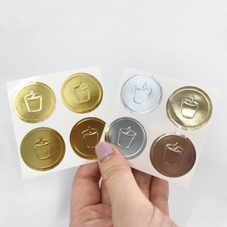 Embossed sticker with glossy silver or gold foil