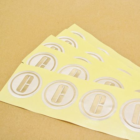 Embossed sticker with glossy silver foil
