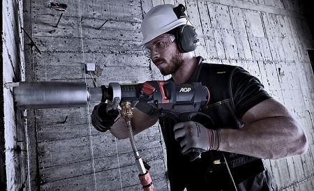 Diamond Coring - Using a drill stand and Diamond coring motor to penetrate a concrete wall.