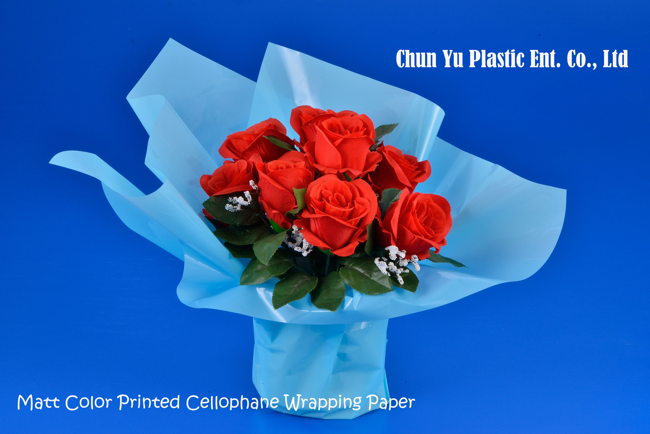Cut flower bouquet wrapped in matt color printed clear cellophane wrapping paper