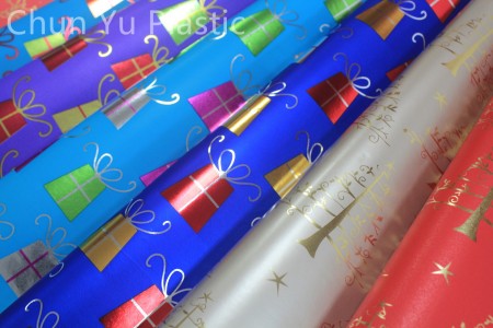 Metallic gift wrapping paper with Christmas design printed