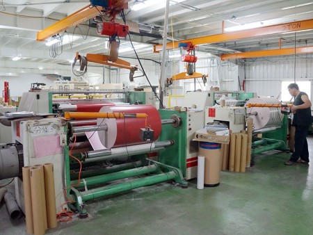 Rewinding machine to make jumbo roll of gift wrapping paper.