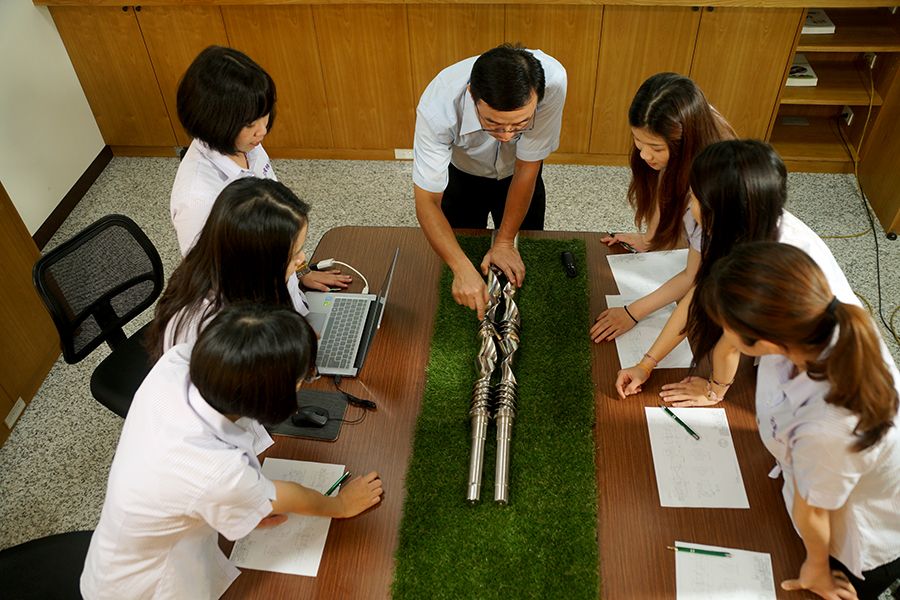 The team is actively engaged in discussions, striving for quality excellence