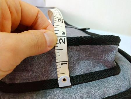 Collapsible front pocket can reach a depth of 2 inches.
