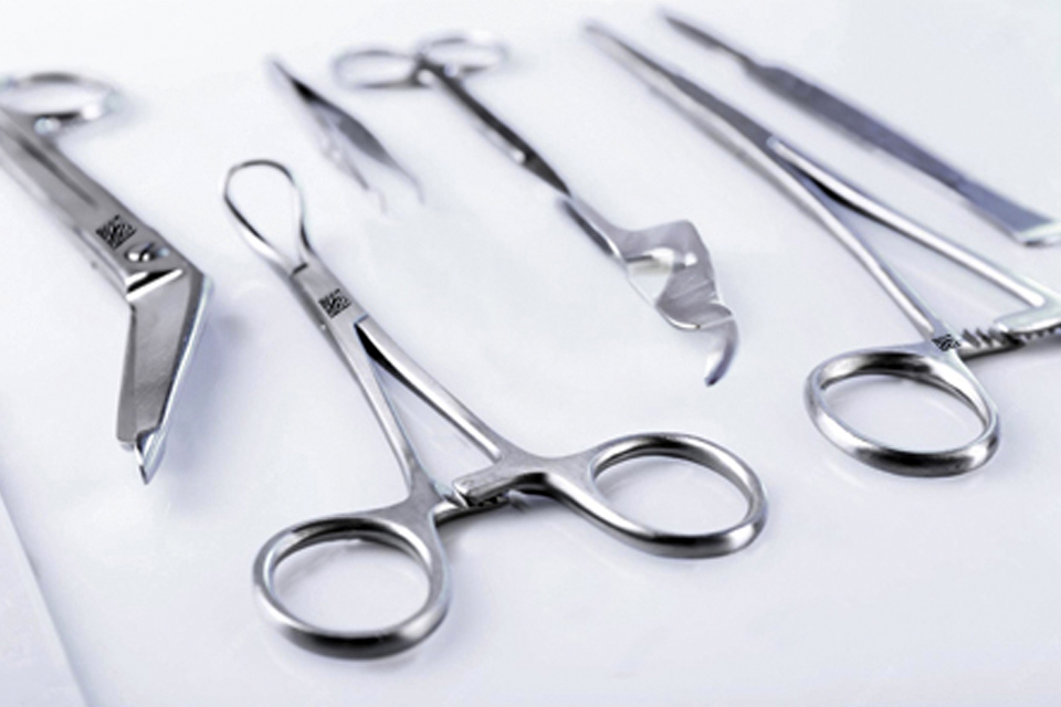 NUMA reader decoding direct part marks on stainless-steel surgical tools.