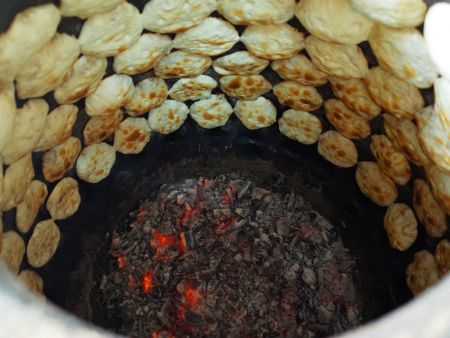 Baking kompia in a traditional oven