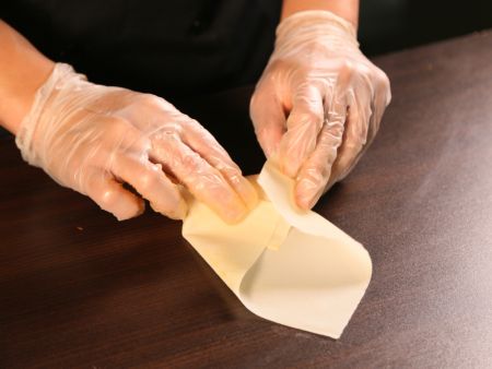 Folding the filling ingredients into the Egg Roll wrapper