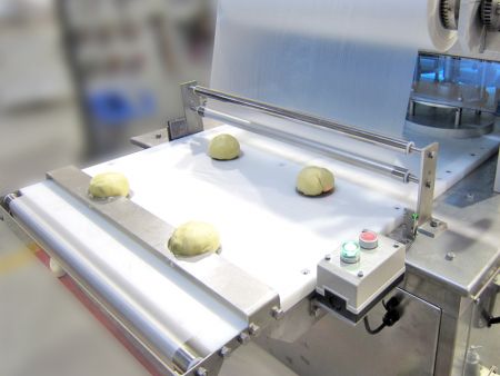 Placing dough balls in position