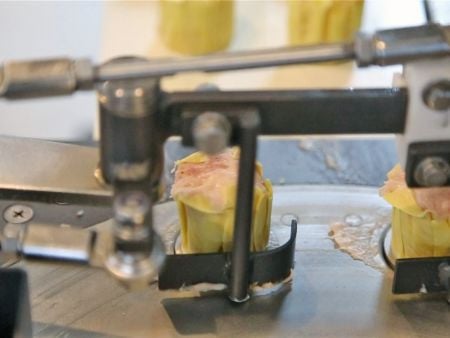 Pushing Siomay products onto the conveyor belt