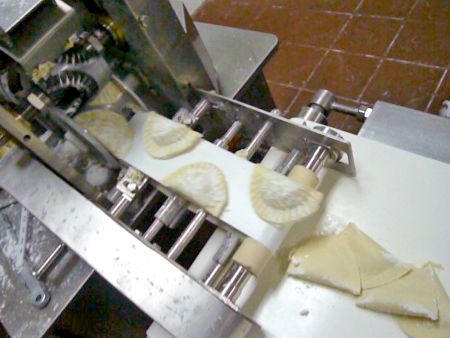 Sambouseks are formed with a mold cutter