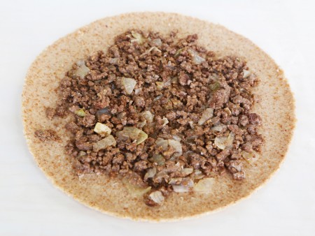 Spread filling on the center of Kubba Mosul Pastry