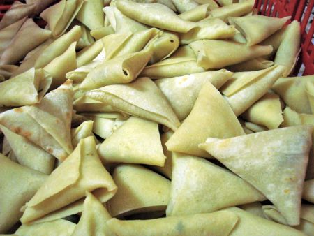 The Rectangular-shaped wrappers are formed into Samosas