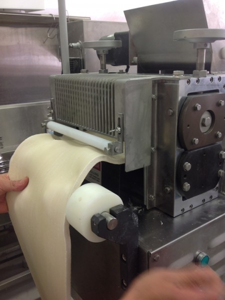 The dough is pressed by the pressing rollers.
