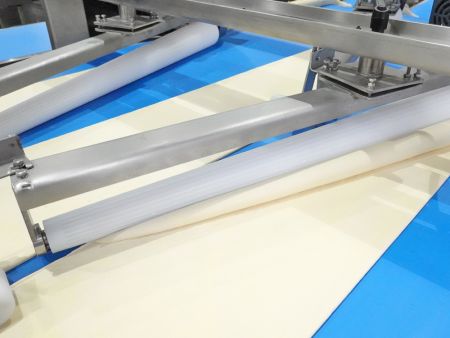 The rolling wheels are staggered to allow each dough sheet to be rolled up separately