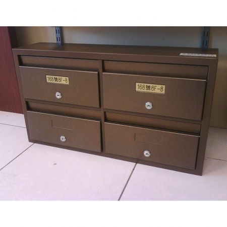 A mini 2*2 cluster mailbox placed on the floor, decorated with Brass Frieze laminated metal plates