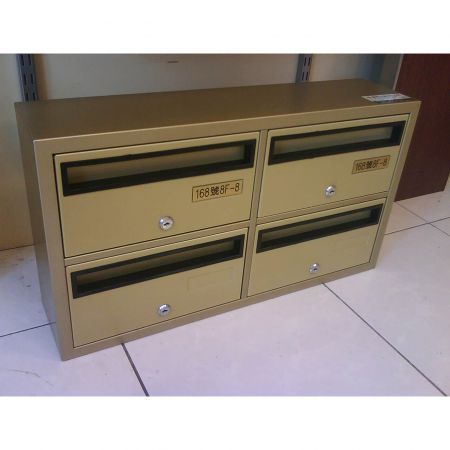 A close-up left side view of a mini 2*2 mailbox placed on the floor, its surface is decorated with Persian Gold laminated metal plate