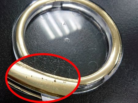 Stamped surface breaks due to the entrapped-air.
