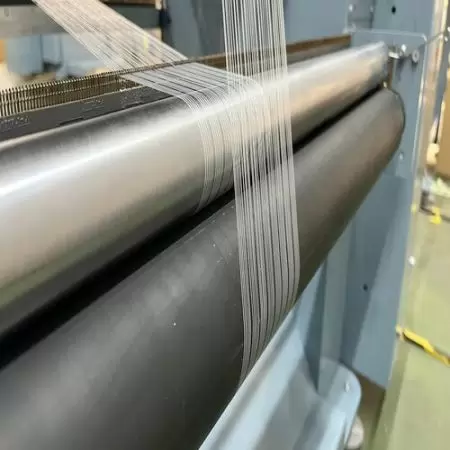 Rouleau d'alimentation de fil de trame