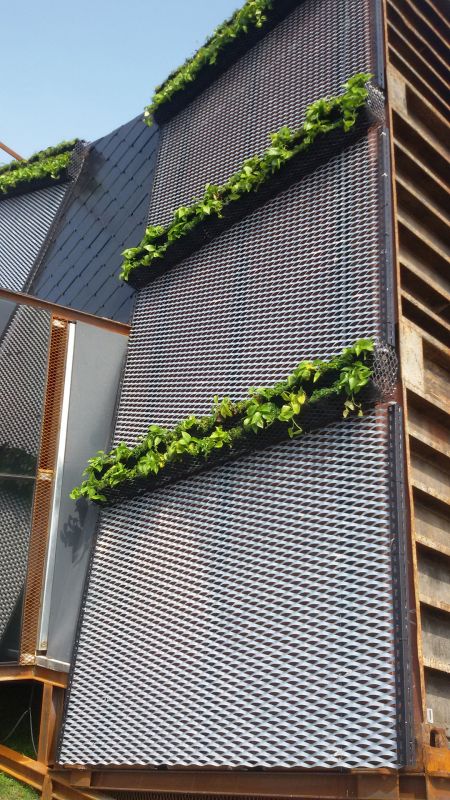 The third application transforms the metal into display shelves, in keeping with the festival's theme of self-sufficiency, by pairing it with a vegetable garden outside the container.