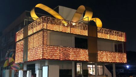 It's adorned with string lights nestled within the mesh openings, transforming it into an attention-grabbing beacon.The use of expanded metal is strategic, as it significantly reduces interior temperatures and minimizes solar gain, increasing the building's environmental efficiency.