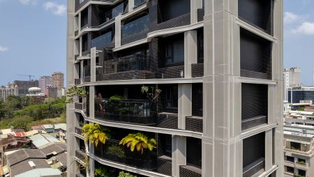 Its distinctive and irregular appearance, featuring a juxtaposition of black and white blocks, stands out from the nearby streets. Surrounded by lush greenery and located in the heart of a culturally rich area, it offers residents a tranquil escape.