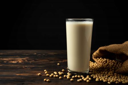 豆漿與體重管理：解析其減重益處 - 一杯豆漿與黃豆原料，象徵天然、健康的飲品，有助於體重管理。