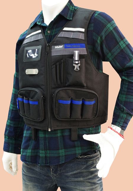 Front of engineer Tool vest with multiple tool pockets, Molle webbing straps, tape holder, phone holder, two large zippered pockets.