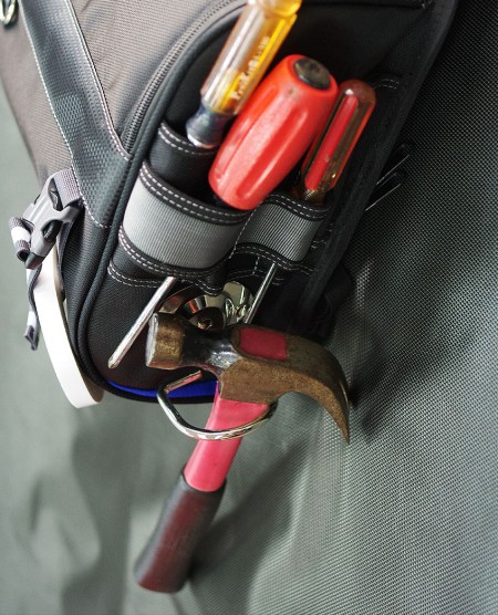 Convenient exterior tool storage slot and hammer holder