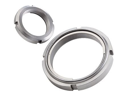 Prevailing torque bearing nut with metal inserts - Prevailing torque bearing nut with metal inserts
