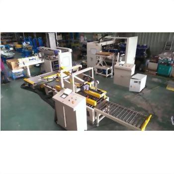 Fully Automatic Counting, Arranging, Filling and Carton Sealing System - Cans & Bottles 10-2 - An overhead view of a white and yellow automated industrial production line with multiple conveyor belts and control panels on a green factory floor.
